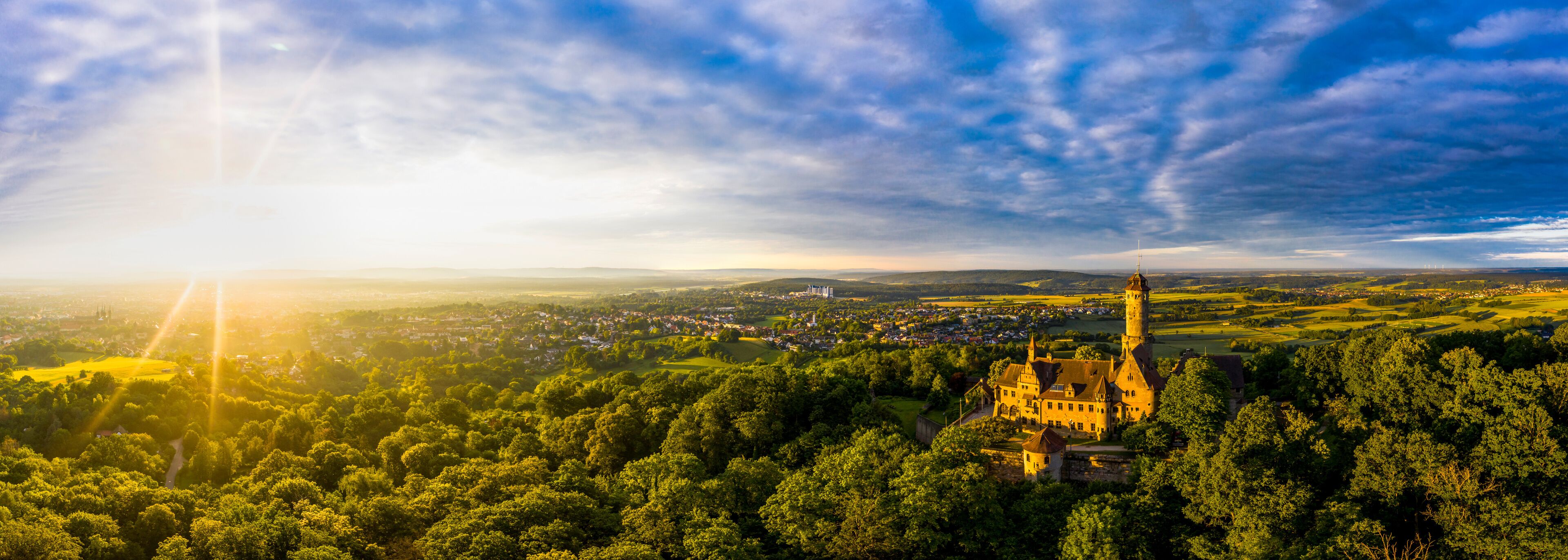 Germany, Bavaria, Bamberg, Helicopter panorama of Altenburg castle at summer sunset