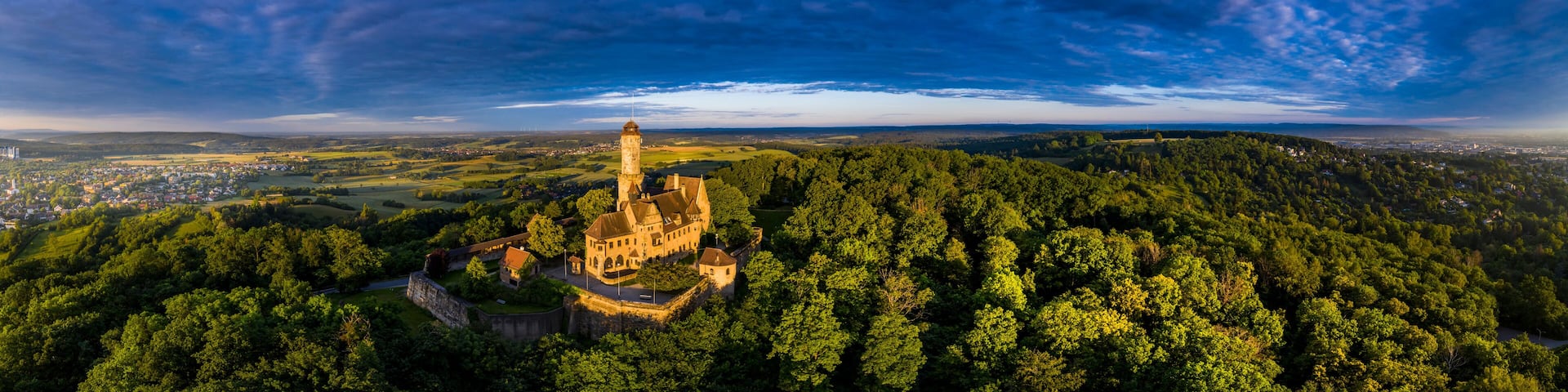 Germany, Bavaria, Bamberg, Helicopter panorama of Altenburg castle at summer dusk