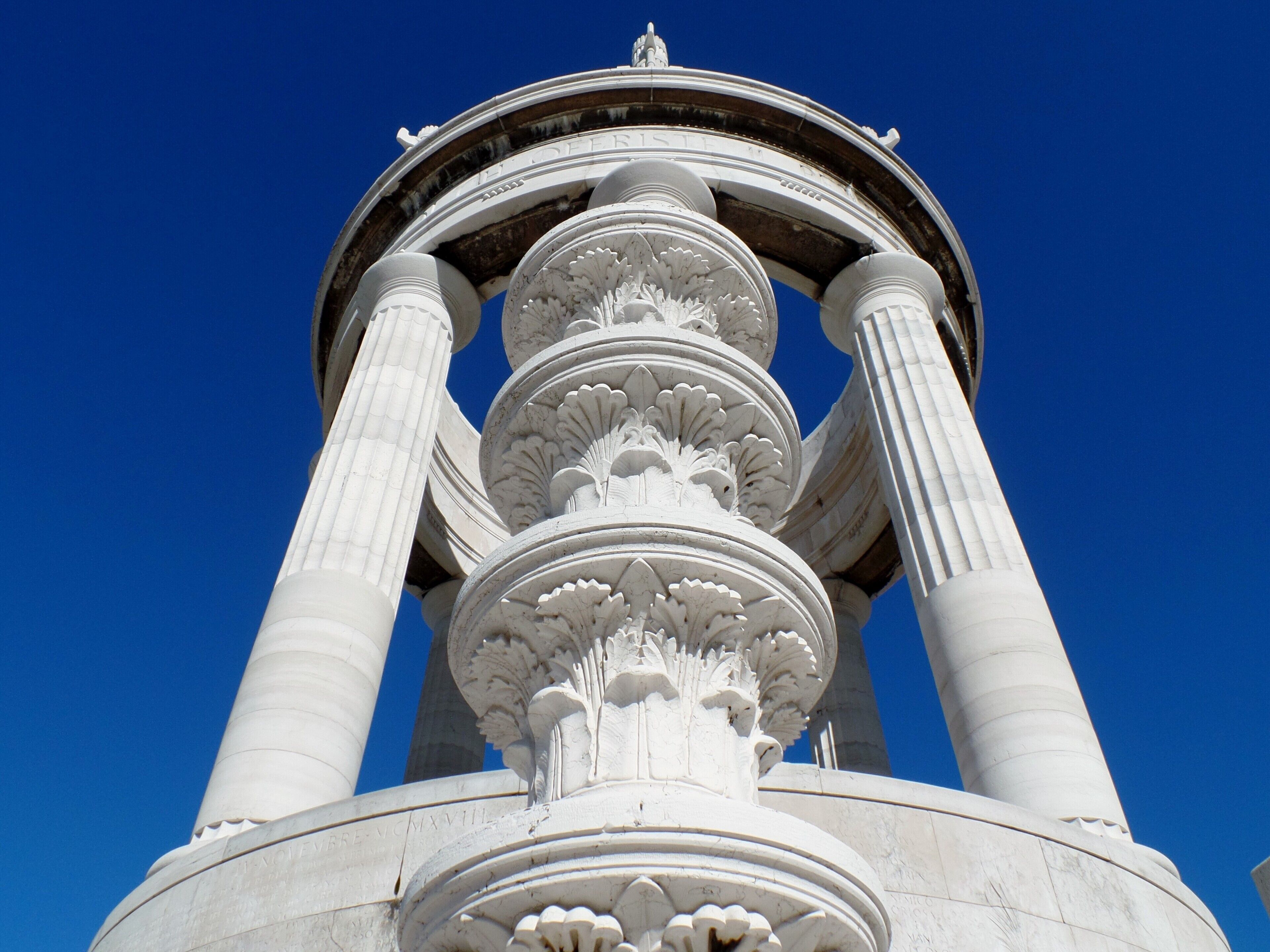 A classical column structure with intricate carvings and inscriptions.
