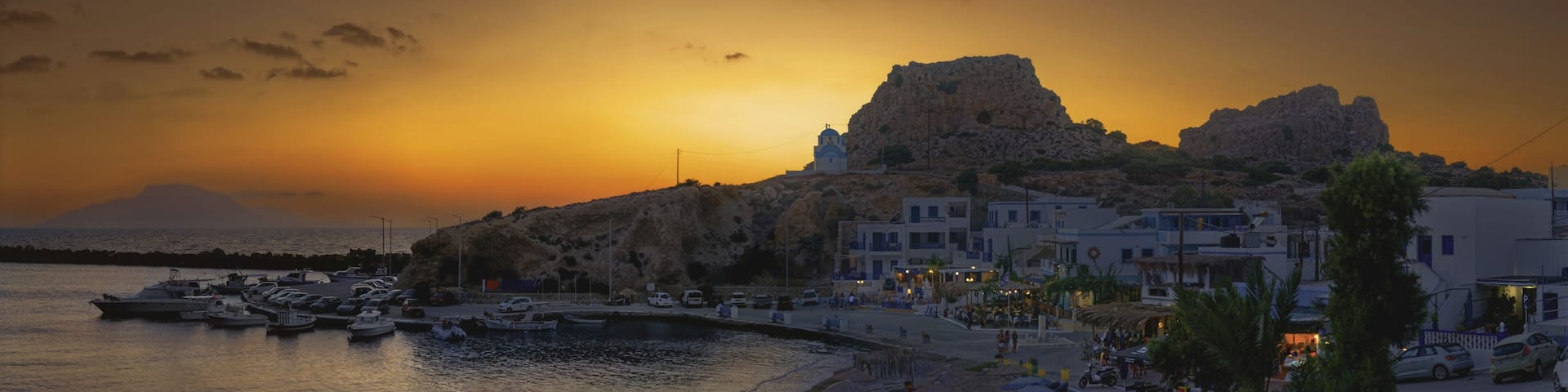 Harbour of the fishing village Finiki at dusk with boats and rocks, fishing village Finiki, Karpathos, Greece
