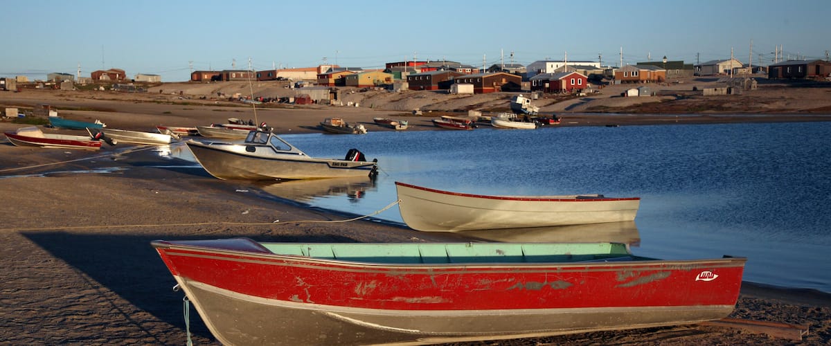 A beach with several boats anchored near the shore.