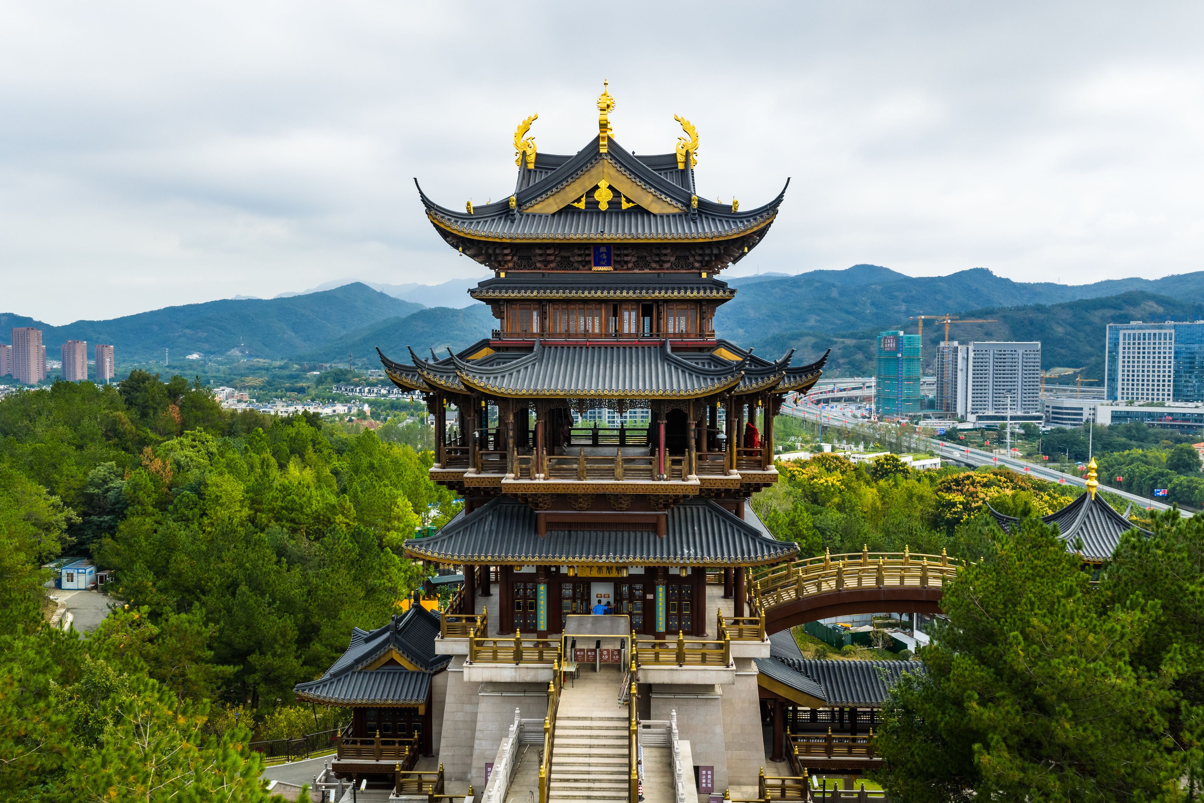 Jimingge Pavilion in Yiwu, Zhejiang with mountain and city skyline