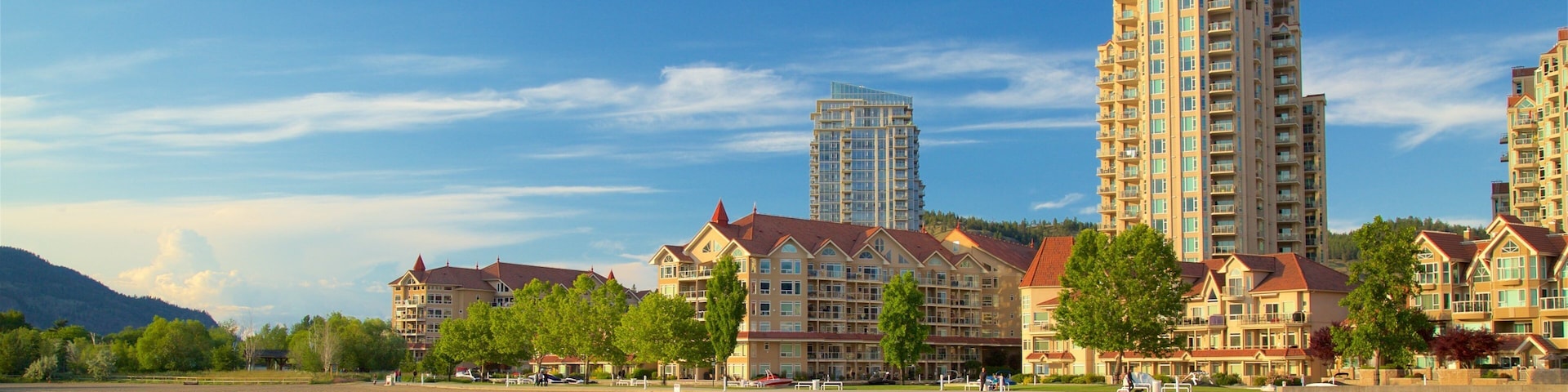 Kelowna featuring a beach and a lake or waterhole as well as a small group of people