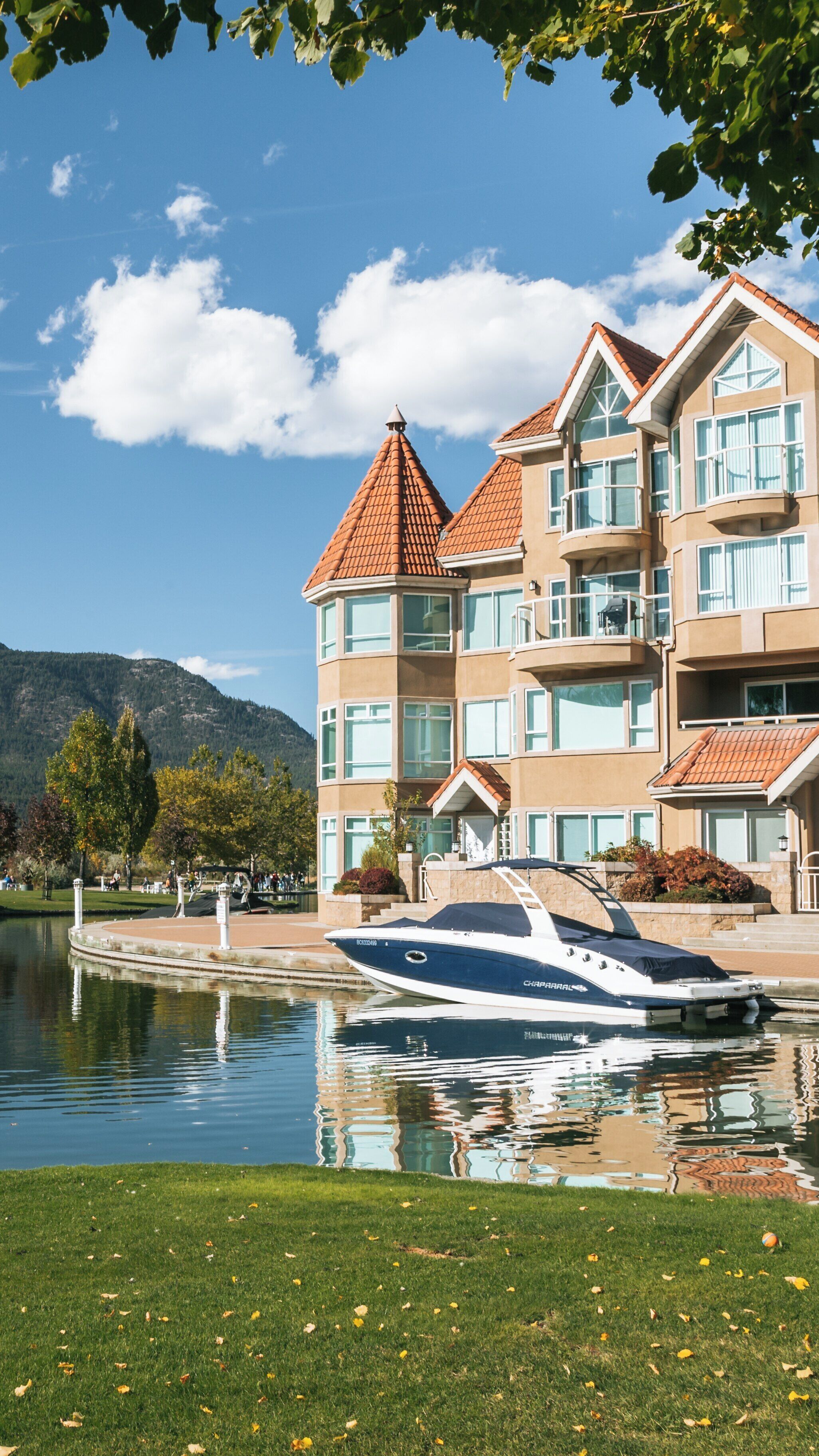 Waterfront Park in Kelowna Central Business District features peaceful surroundings and a boat ready for leisure activities in beautiful British Columbia, Canada