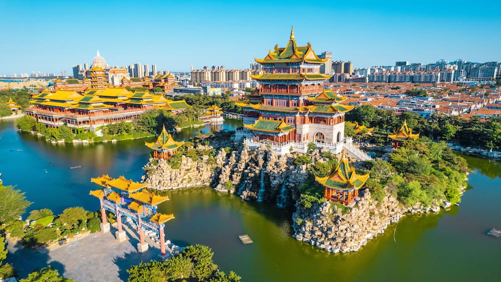 Ein traditioneller chinesischer Architekturkomplex mit mehreren Pagoden und einem großen Wasserspiegel.