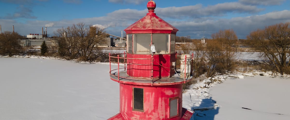 Alpena, Michigan historic lighthouse along Lake Huron in the winter.