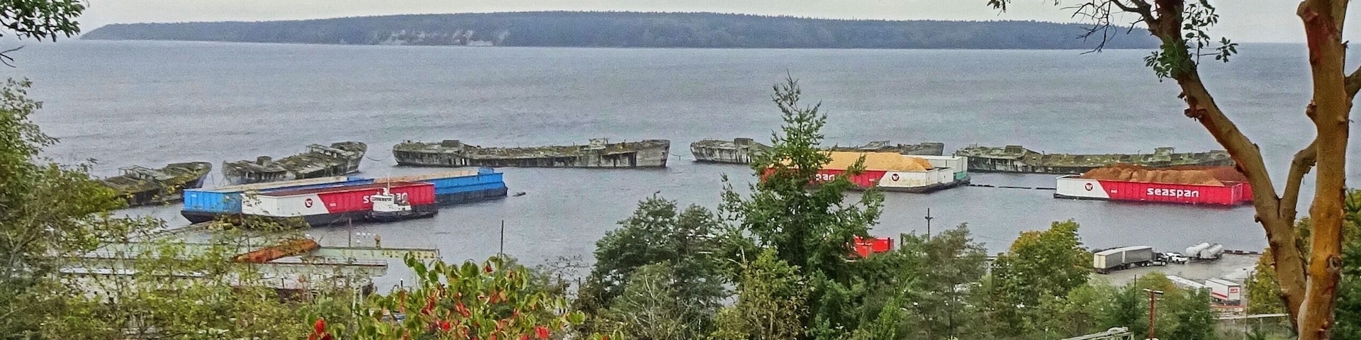Located in Powell River, BC. When the U.S. entered WWI in 1917, they embarked on a program of shipbuilding to offset heavy losses to merchant shipping from German U-Boats. As steel plate was in such great demand, government support was given for the building of seagoing ferro-concrete ships.
The WWII concrete ship-building program was more successful than its WWI counterpart. Construction was much stronger due to better cement and more steel reinforcements. Concrete bottoms, which eliminated condensation issues in steel ships, were well-suited for carrying dry cargo. These vessels handled well but were only capable of a maximum of 10 knots. All of the dismantled hulks were proud ships in their day - some fought battles of freedom, while others carried full cargoes along the world’s trade routes.
In the late 1940s, after rust and rot holed many of the original steel ships, Macmillan Bloedel settled on the collection of concrete vessels as a more permanent solution to their breakwater dilemma. 
(September 2019)
#LocalSecrets #Trovember #History