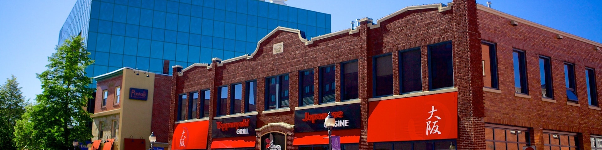 A street with a red-brick building housing a Japanese restaurant and a Tappanyaki Grill.