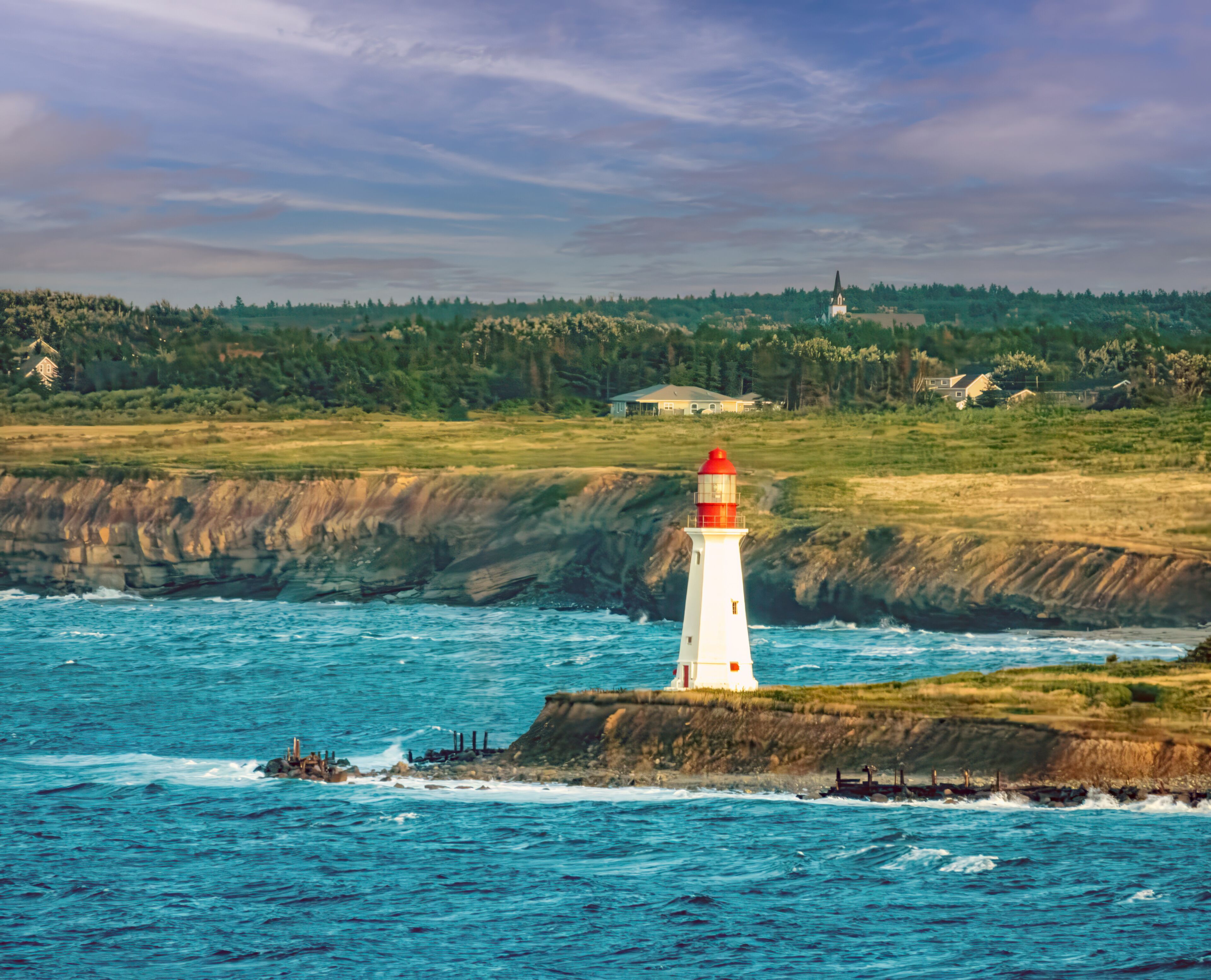 Lighthouse and a ship wreck at the entrance of Sydney harbor, Nova Scotia, Canada