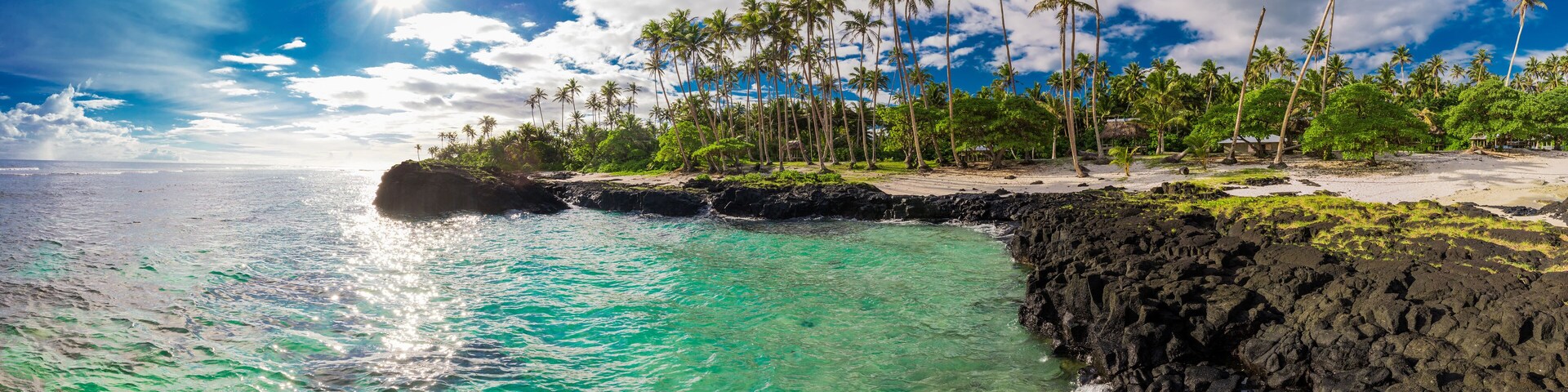 Tropical volcanic beach on Samoa Island with many palm trees
