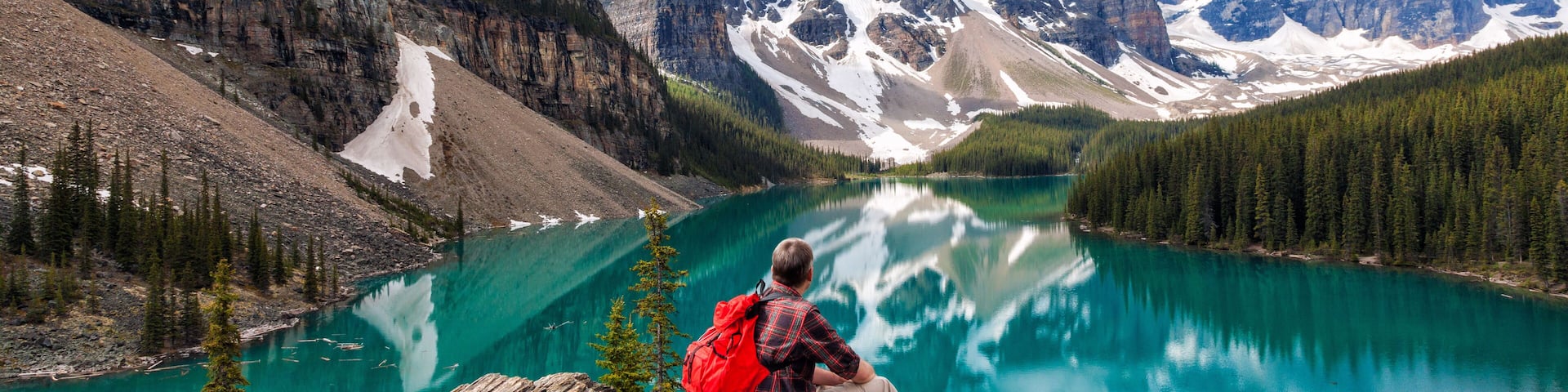Hiking Man Looking at Moraine Lake & Rocky Mountains Panorama
