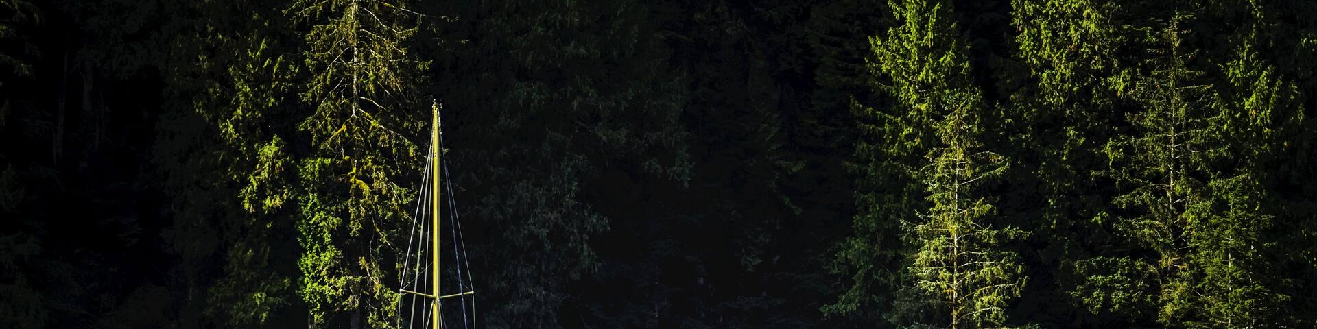 Sailboat in the Great Bear Rainforest at sunrise; Hartley Bay, British Columbia, Canada