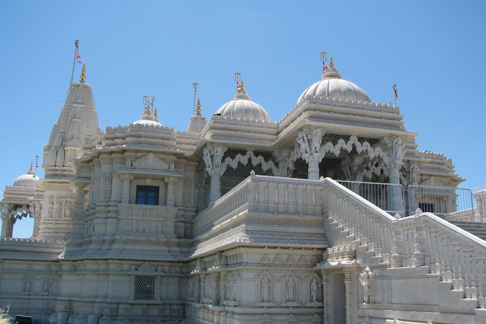 Un templo blanco con cúpulas múltiples y tallas intrincadas.