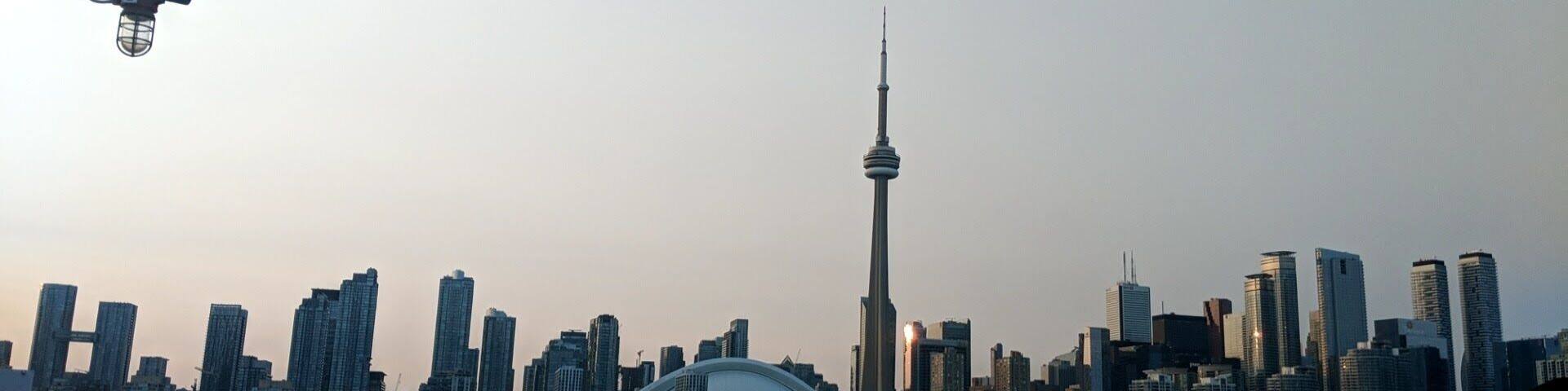 A city skyline with a prominent tower and modern buildings.