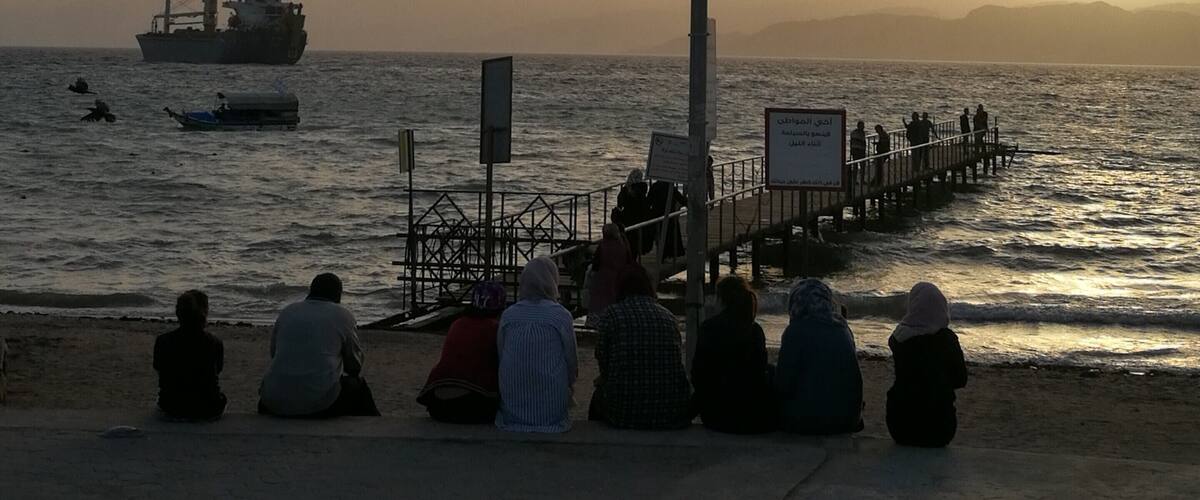 The locals rest on the city beach of Aqaba in Jordan watching the sunset to the Red Sea and the passing ships. The hills across the Aqaba bay is already Egypt. Travel tip: if you don't want to spend your time at the crowded by locals city beach go Tala Bay area - it's only 9 km from Aqaba and the quality of the beach and water is great  #LifeAtExpedia