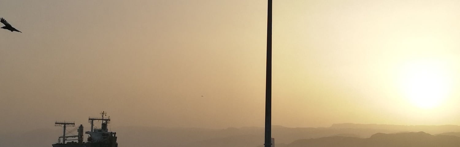 The locals rest on the city beach of Aqaba in Jordan watching the sunset to the Red Sea and the passing ships. The hills across the Aqaba bay is already Egypt. Travel tip: if you don't want to spend your time at the crowded by locals city beach go Tala Bay area - it's only 9 km from Aqaba and the quality of the beach and water is great  #LifeAtExpedia