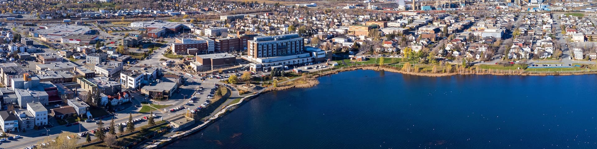 Aerial view of Rouyn-Noranda City and Osisko Lake in a fall season sunny day. Abitibi-Temiscamingue, Quebec, Canada.