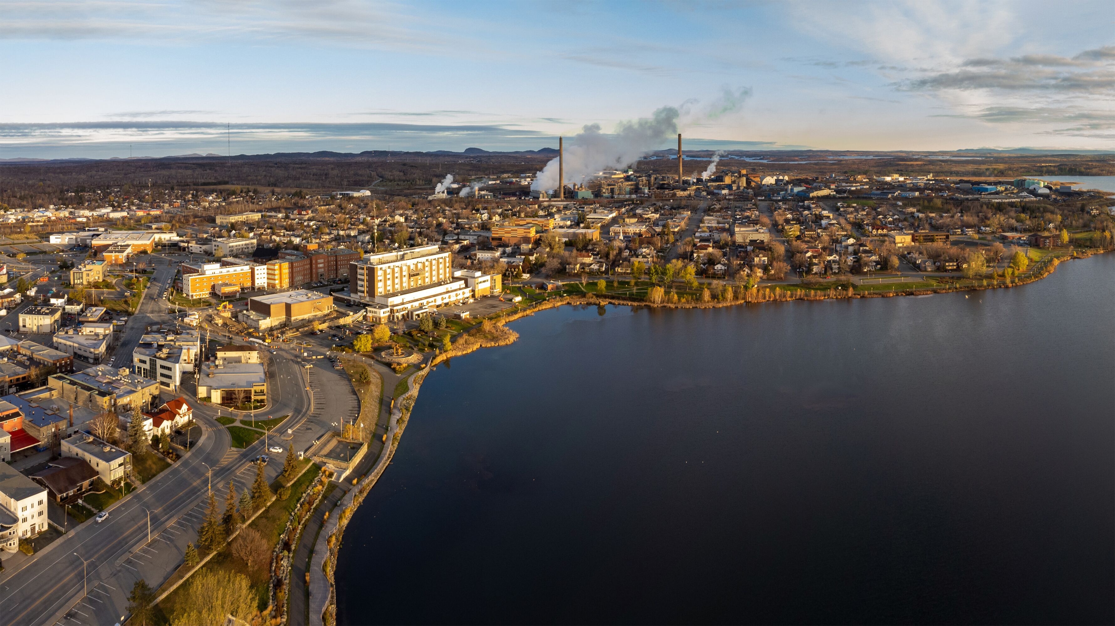Aerial panoramic view of Rouyn-Noranda City and Osisko Lake on sunset time. Abitibi-Temiscamingue, Quebec, Canada.