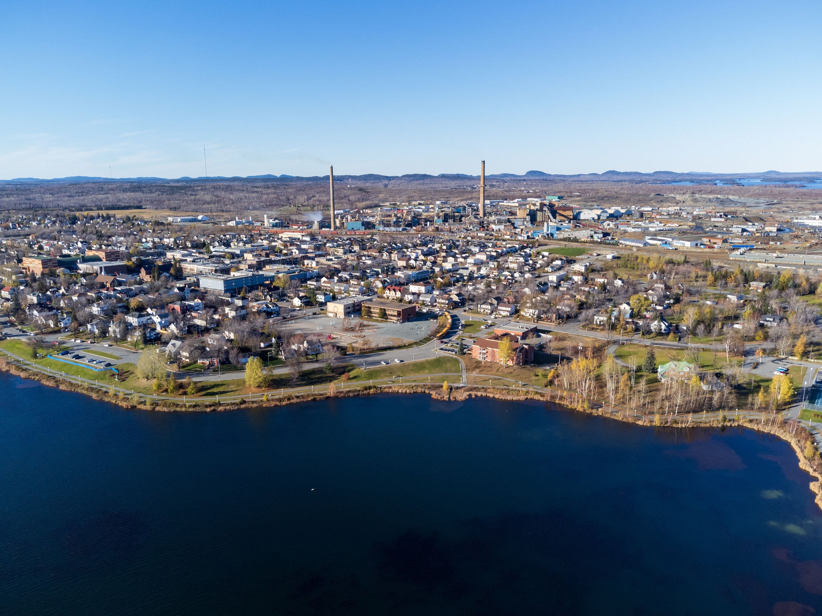 Aerial view of Rouyn-Noranda City and Osisko Lake in a fall season sunny day. Abitibi-Temiscamingue, Quebec, Canada.