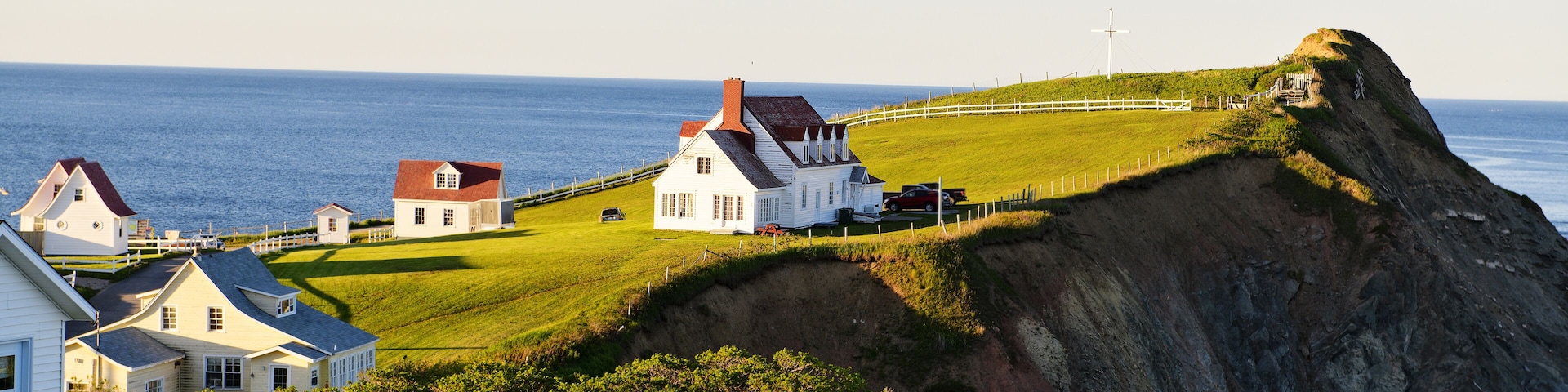 A Bonaventure Island and fisherman houses and Perce Rock in Gaspesie