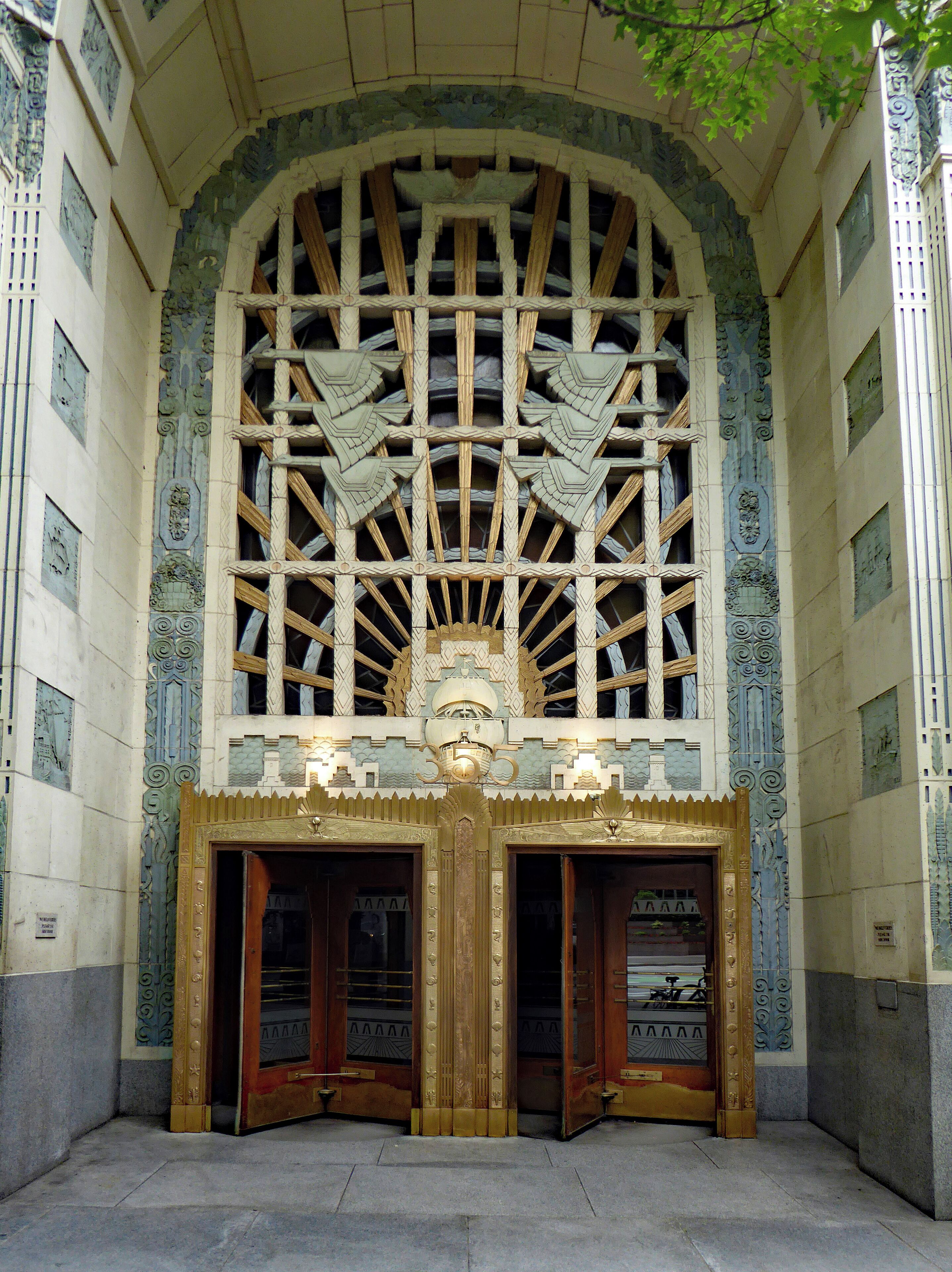 The magnificent entrance to the Marine Building skyscraper in Downtown Vancouver. It was completed in 1930 and at the time of its opening was the city's tallest skyscraper. At 22 floors it is small in comparison to the modern buildings that surround it but it remains one of the most iconic buildings in Vancouver and listed among the best Art Deco buildings in the world. It owes its name to the many fine marine-themed ornaments that decorate it.  All over the walls and polished brass doors are depictions of sea snails, skate, crabs, turtles, carp, scallops, seaweed and sea horses, as well as the transportation means of the era. Because of its iconic architecture and luscious interior decorations, the building has been chosen as the setting of a number of film and television productions.