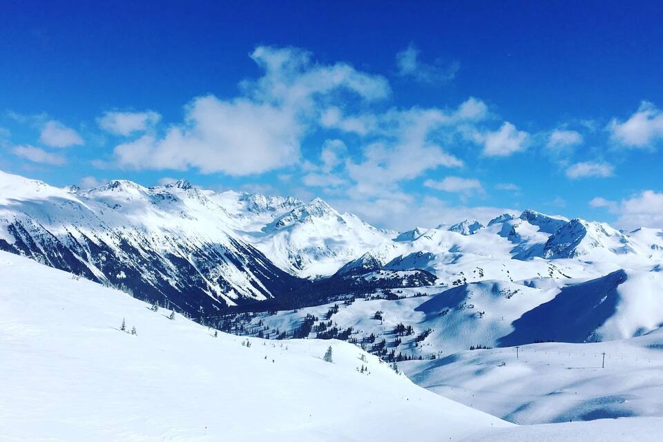 A snow-covered mountain range with clear blue skies.