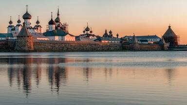 Panoramic view of the Spaso-Preobrazhensky Solovetsky Monastery from the side of the Holy Lake on a sunny cloudless morning, Solovetsky Island, Arkhangelsk region, Russia