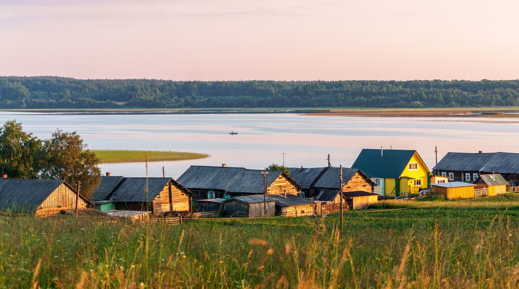 Wooden church on the top of the hill. Vershinino village sunset view. Arkhangelsk region, Northern Russia.