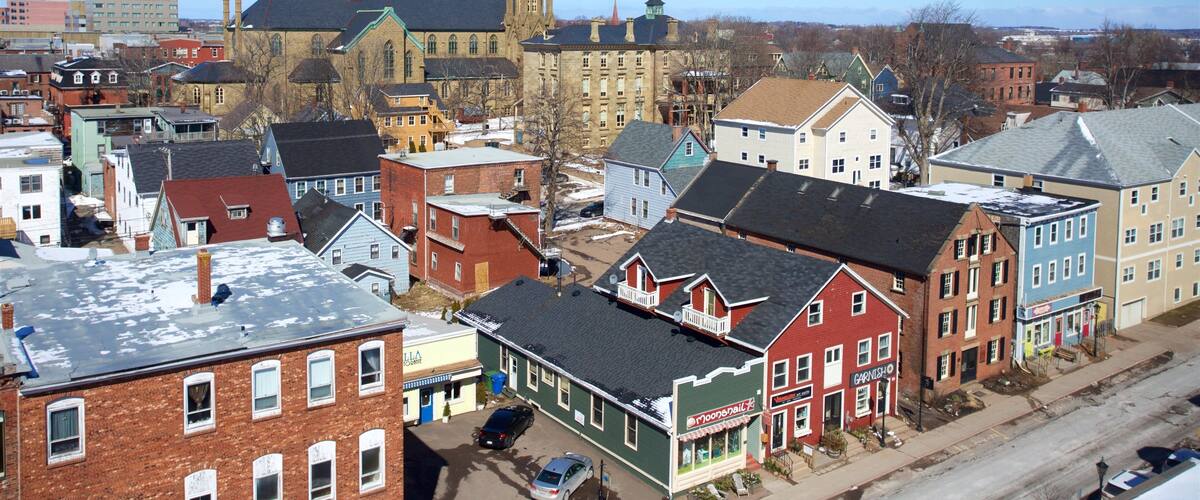A town with historic buildings, a church with twin spires, and a mix of residential and commercial structures.
