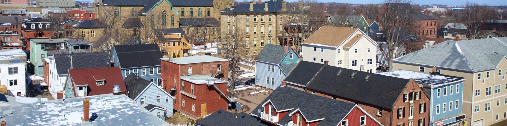 A town with historic buildings, a church with twin spires, and a mix of residential and commercial structures.