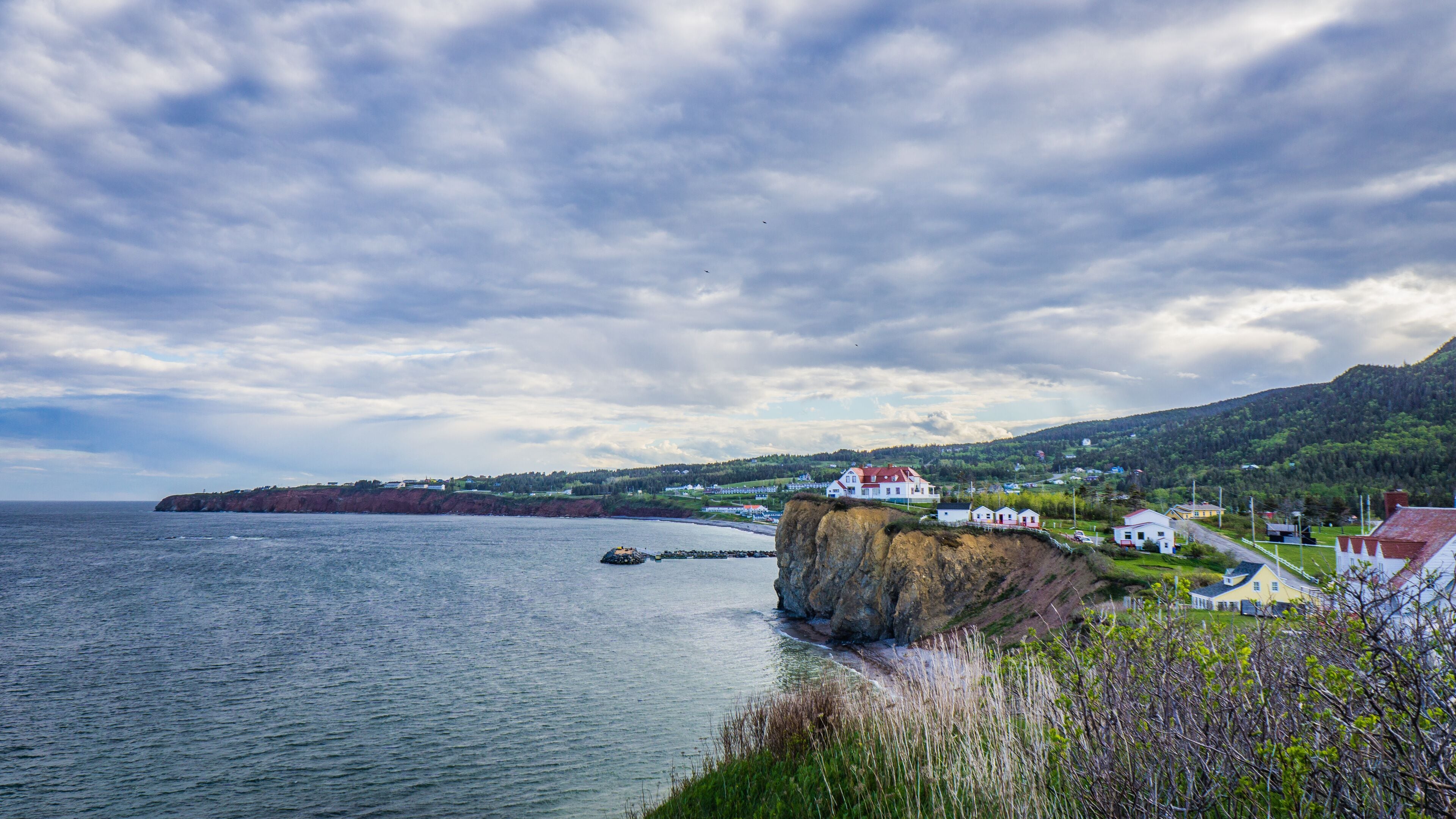 View on Percé, the road 132, the cliffs, the beach and the ocean from Cape Mont Joli next to the Percé Rock in Quebec (Canada)