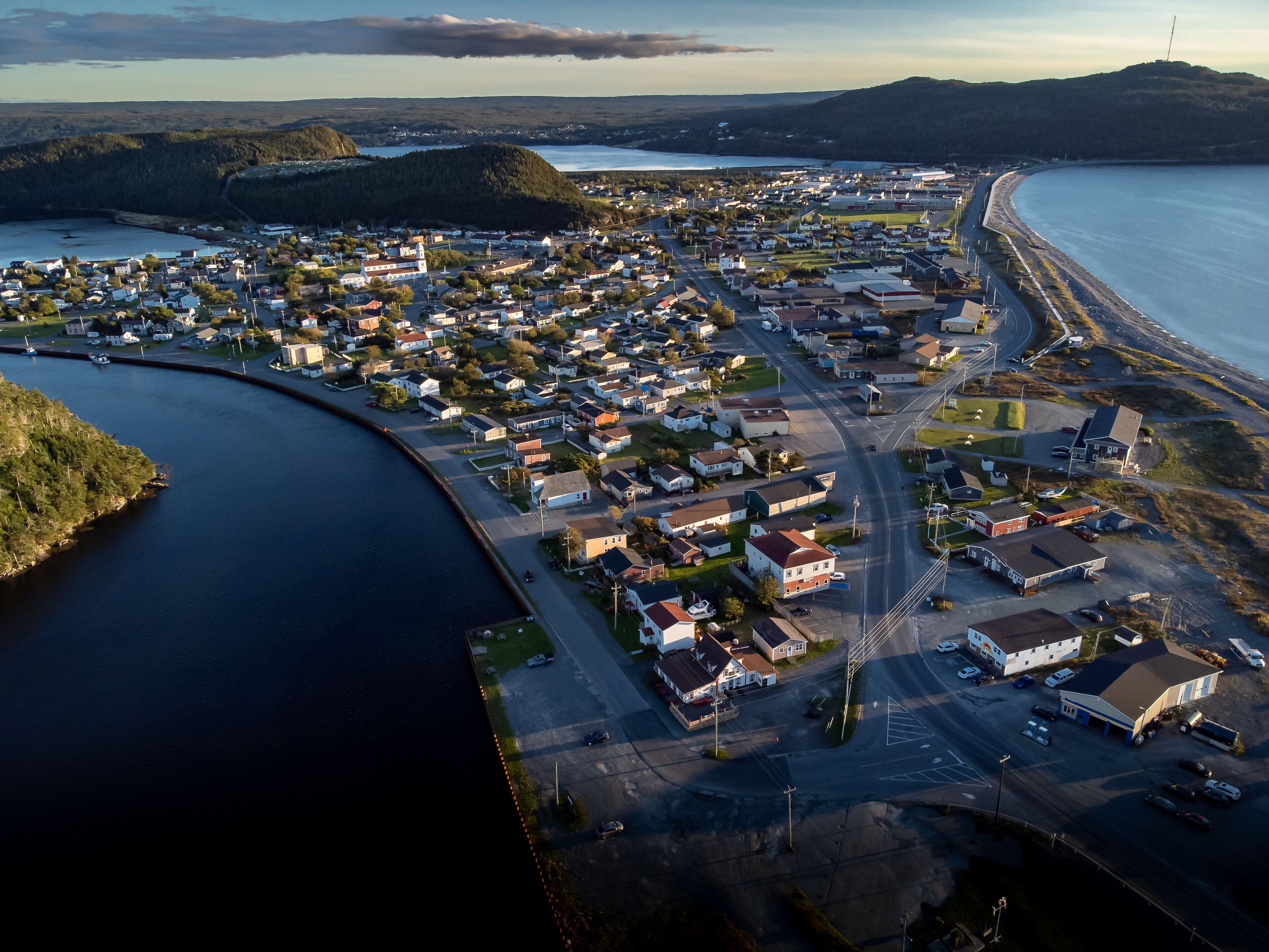 Aerial sand spit town of Placentia Newfoundland overlooking the East coast of canada and waterfront homes with beaches.