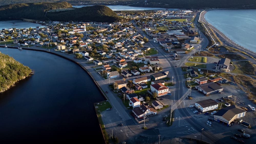 Aerial sand spit town of Placentia Newfoundland overlooking the East coast of canada and waterfront homes with beaches.