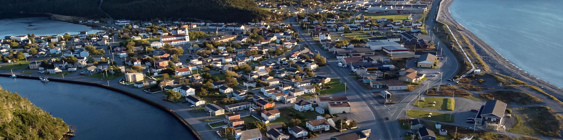 Aerial sand spit town of Placentia Newfoundland overlooking the East coast of canada and waterfront homes with beaches.