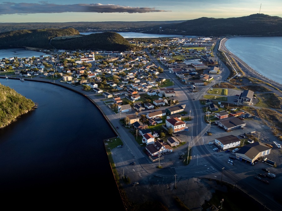 Aerial sand spit town of Placentia Newfoundland overlooking the East coast of canada and waterfront homes with beaches.