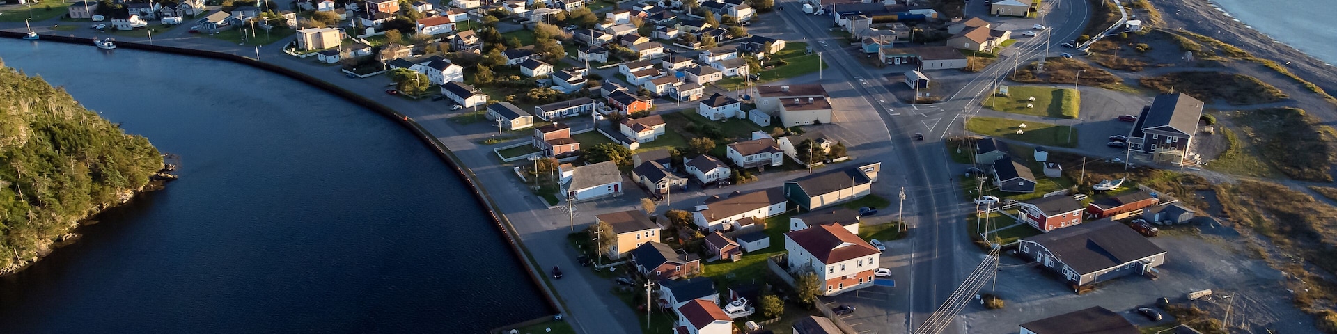 Aerial sand spit town of Placentia Newfoundland overlooking the East coast of canada and waterfront homes with beaches.