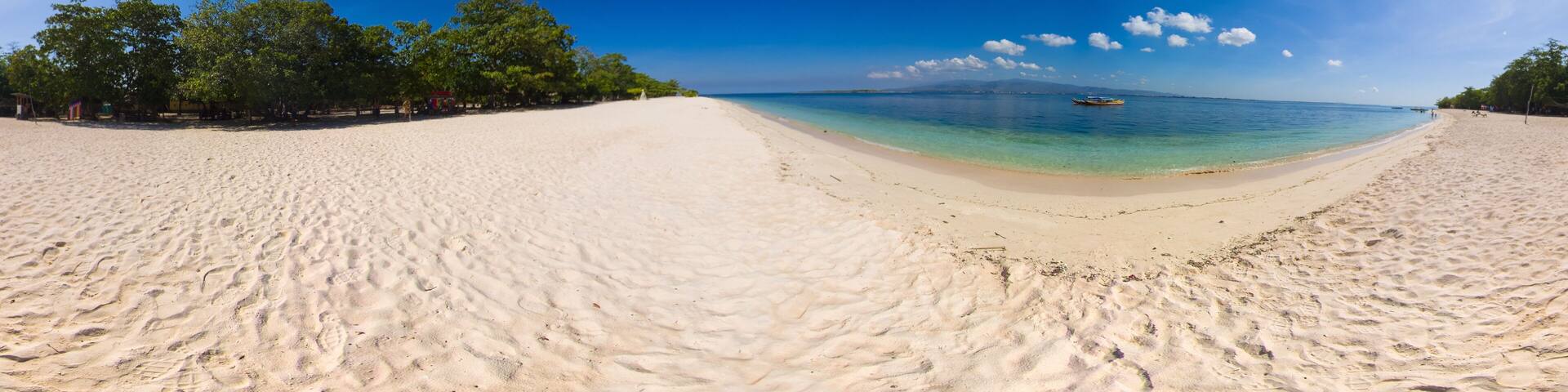 Island with a sandy beach and azure water surrounded by a coral reef and an atoll. Great Santa Cruz island. Zamboanga, Mindanao, Philippines.