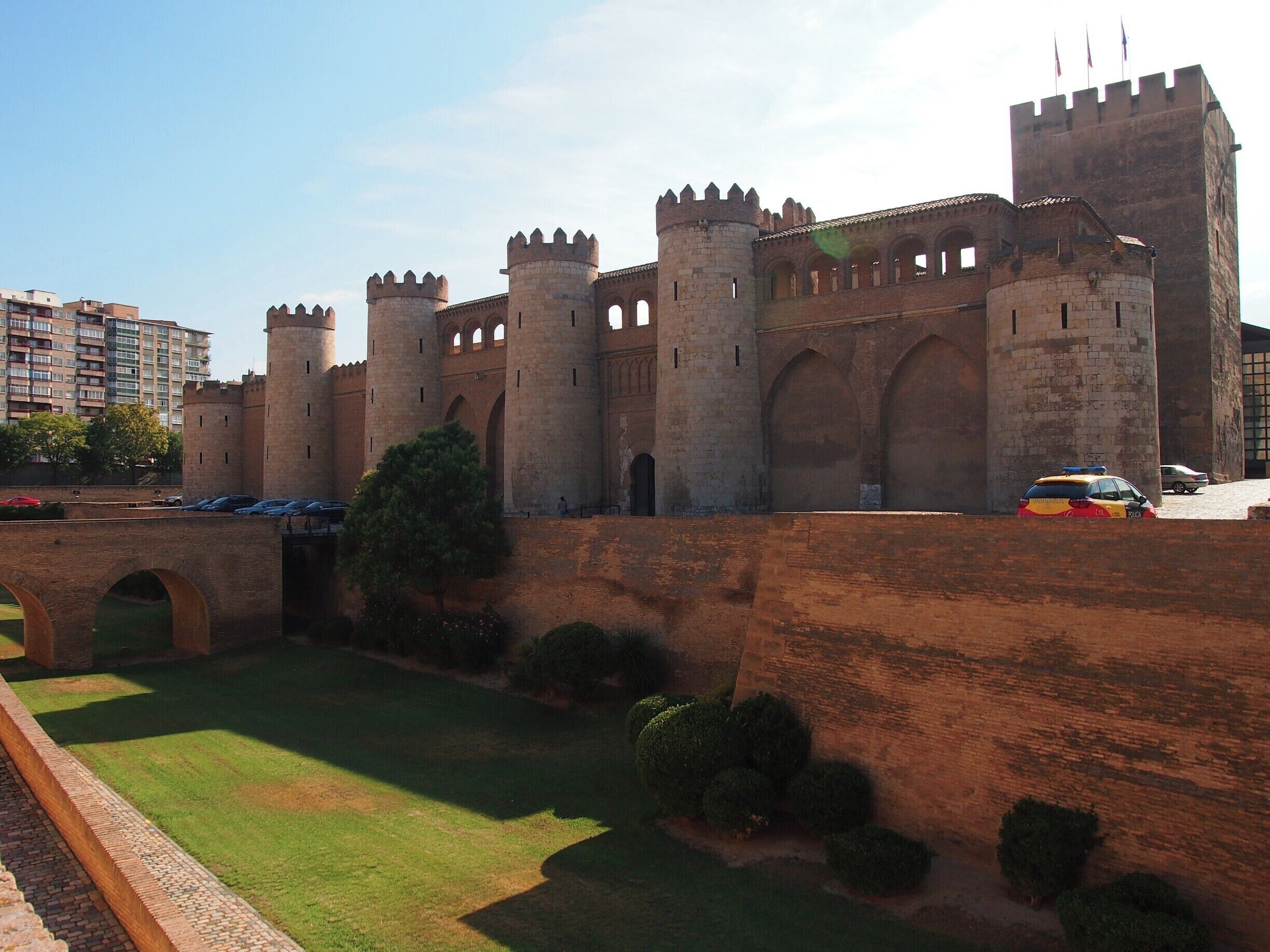 A historic castle with multiple towers and arched walkways.