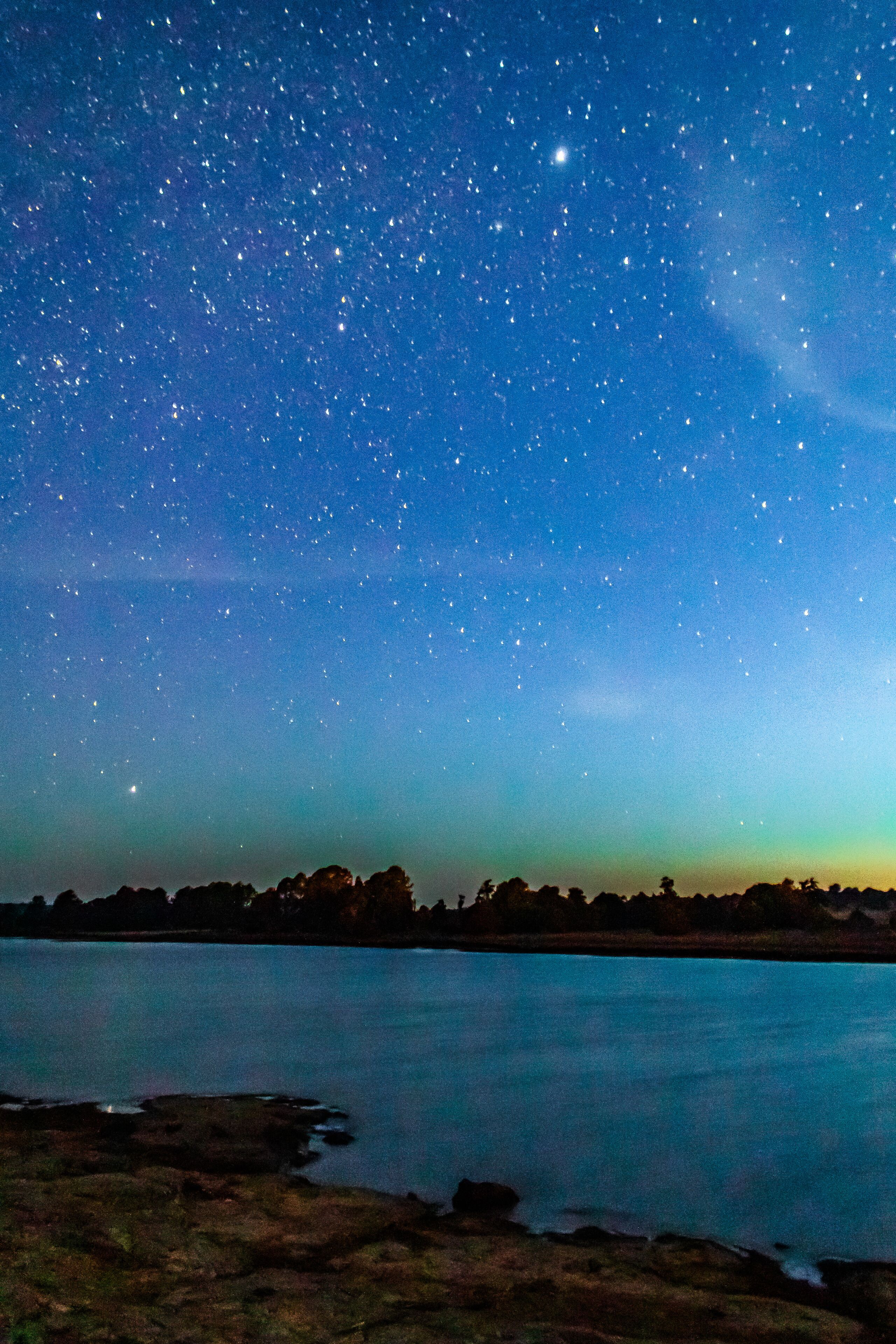 Lagoon at starry night with windmills on the shore, Laguna de los Gamboa in Monte Escobedo, Zacatecas
