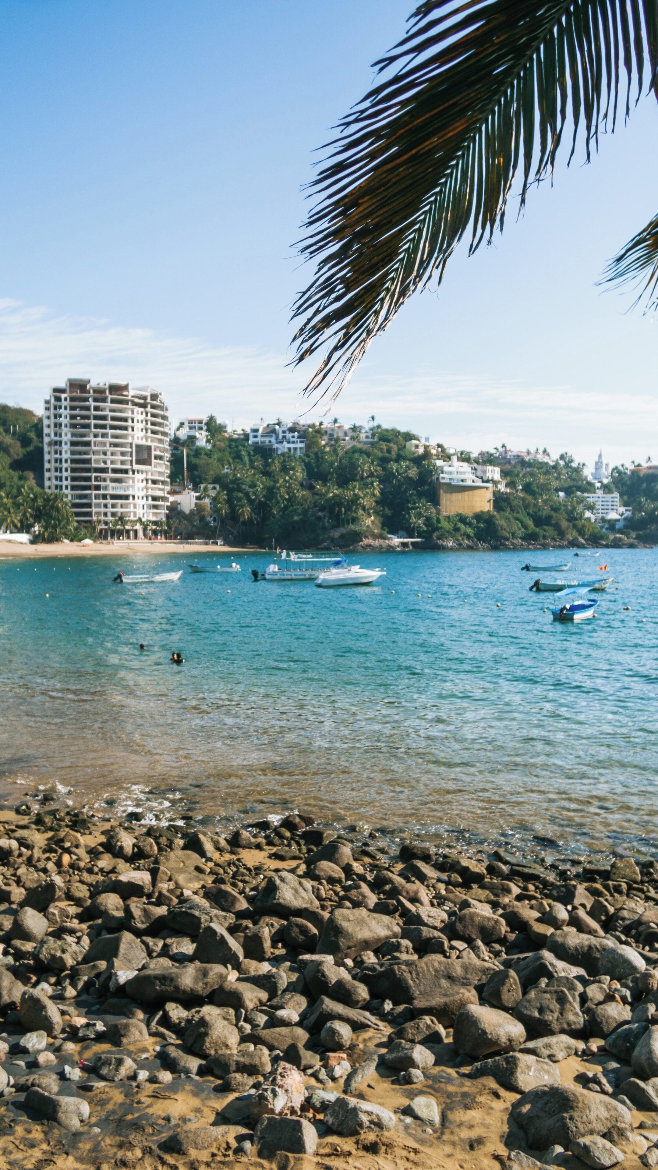 Beautiful Playa La Audiencia in Manzanillo Colima with calm waters and boats on a clear day capturing the essence of coastal Mexico