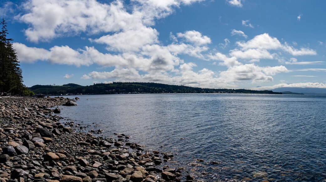 rocks on the shore of the Queen Charlotte Strait blue sky