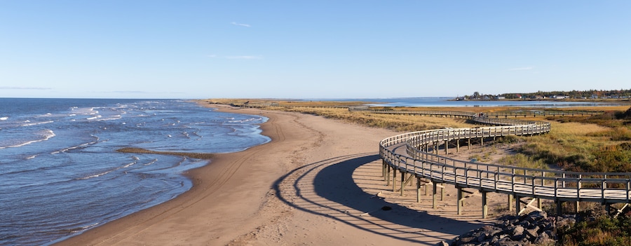 Panoramic view of a beautiful sandy beach on the Atlantic Ocean Coast. Taken in La Dune de Bouctouche, New Brunswick, Canada.