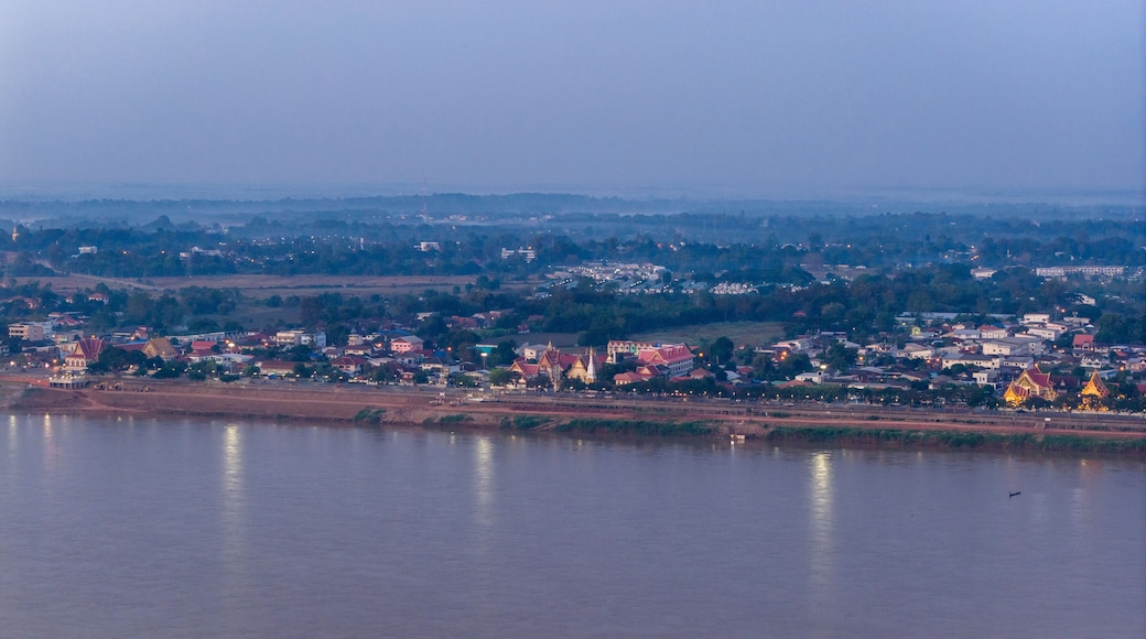 Drone shot of the Savannakhet riverfront at dusk. The image captures the relationship between the urban settlement and the Mekong River border.