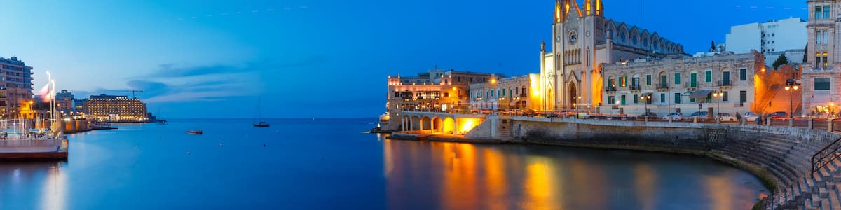 Balluta Bay and Neo-Gothic Church of Our Lady of Mount Carmel, Balluta parish church, during evening blue hour, Saint Julien, Malta
