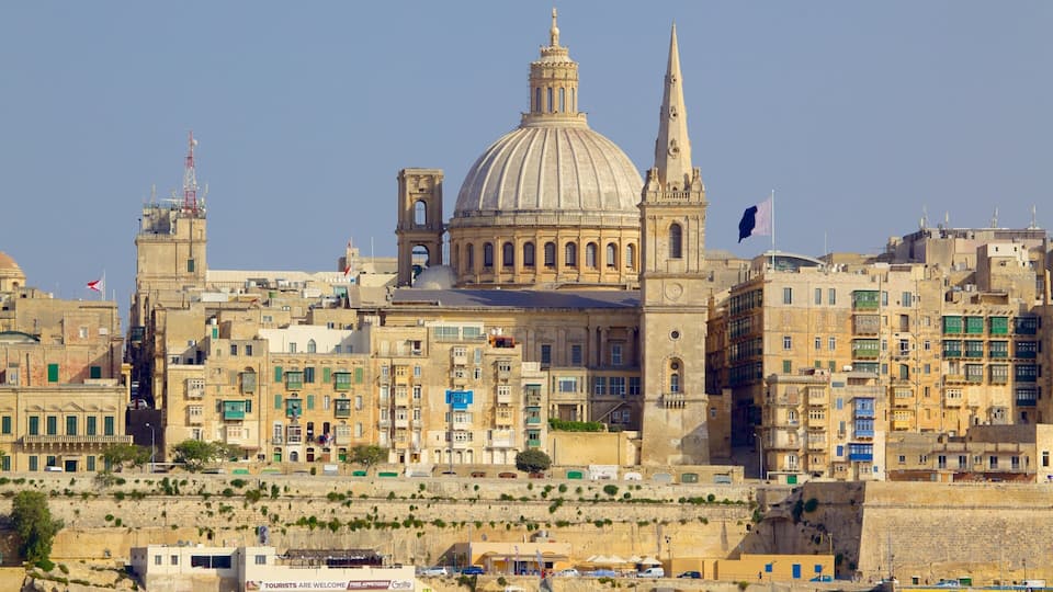 A historic cityscape with a prominent dome and spires, surrounded by densely packed buildings.