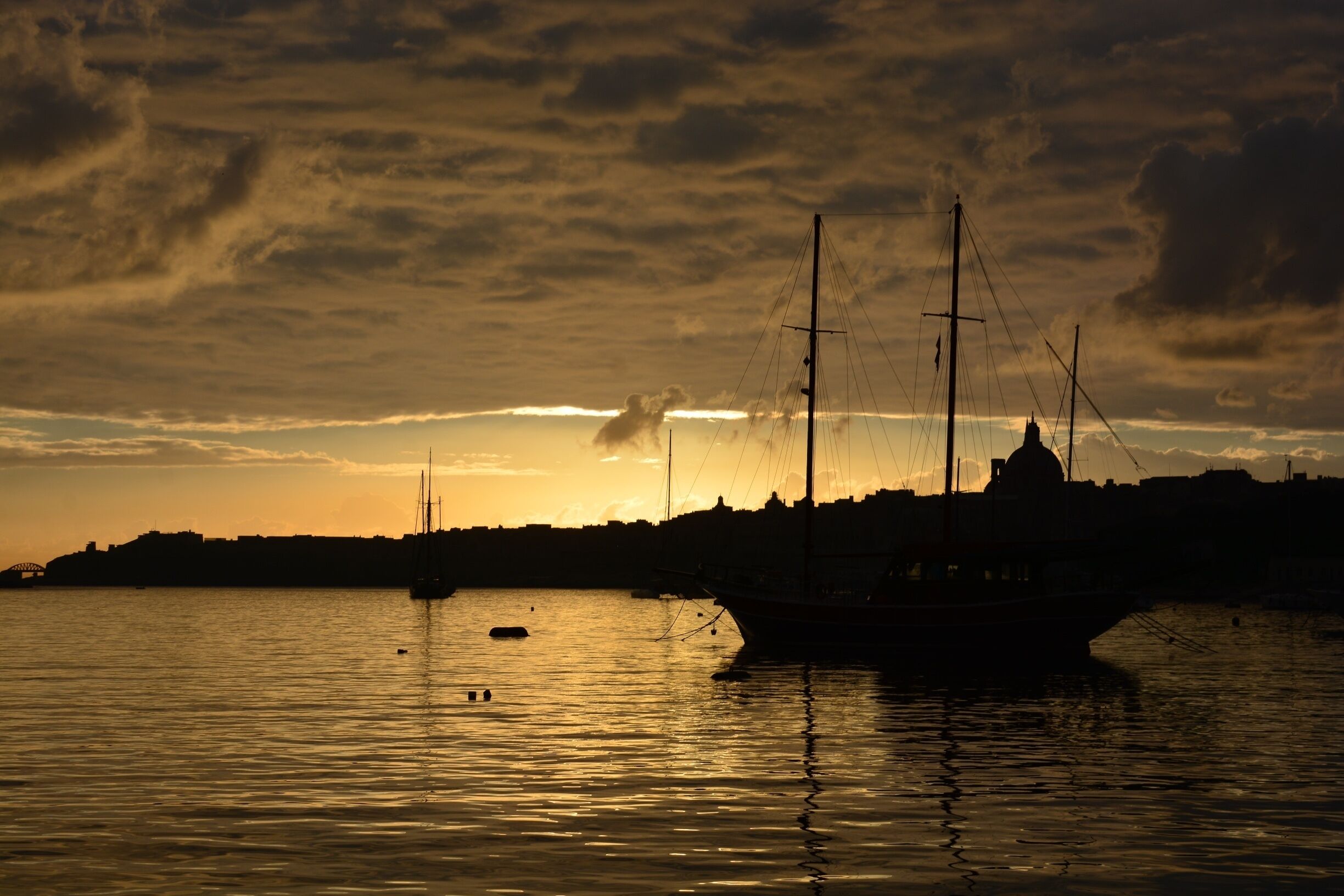 MALTA 
“#goldenhour” “#waterlust”
Just at the right place at the right time ....the last day of Malta trip in January ... I woke up very early by force, because the bus to the airport .... Then this magical surprise at the bus stop. Just turned around and ...wow!        
I was absolutely delighted .... and not prepared, because I did not expect that!  I just started shooting  ... This photos have something magical for me I really do not want to touch the pictures from the sunrise  by any post edition ,because  I really like them for what they are .... Pure, original .... magical ...
