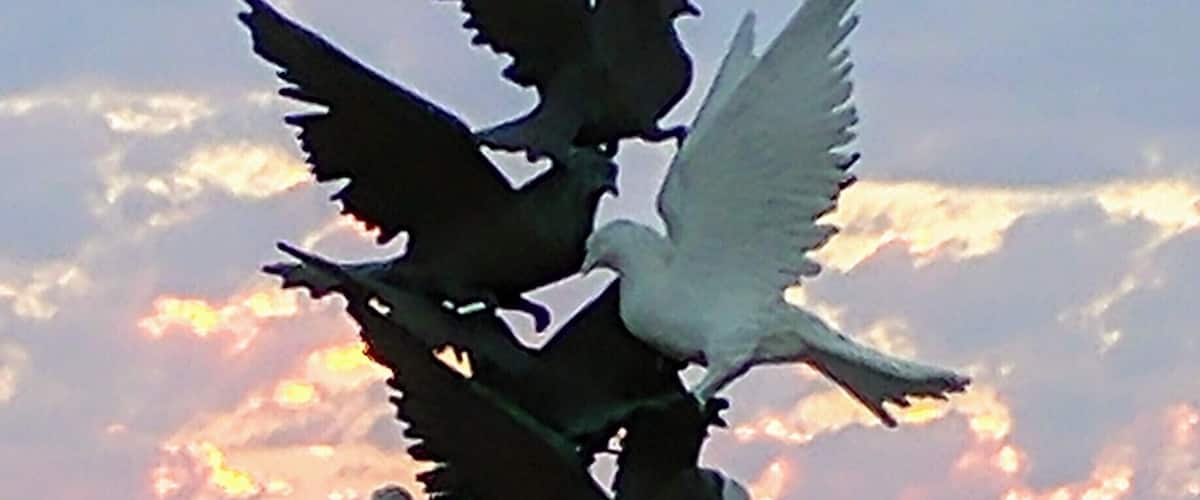 Statue in the middle of the beach overlooking the Aegean sea.
