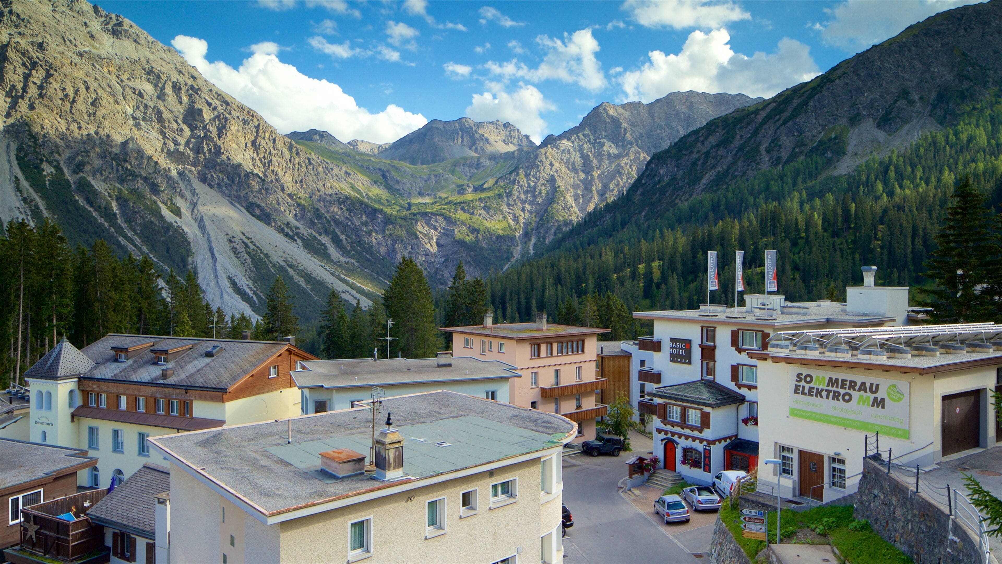 Arosa which includes a small town or village, mountains and landscape views
