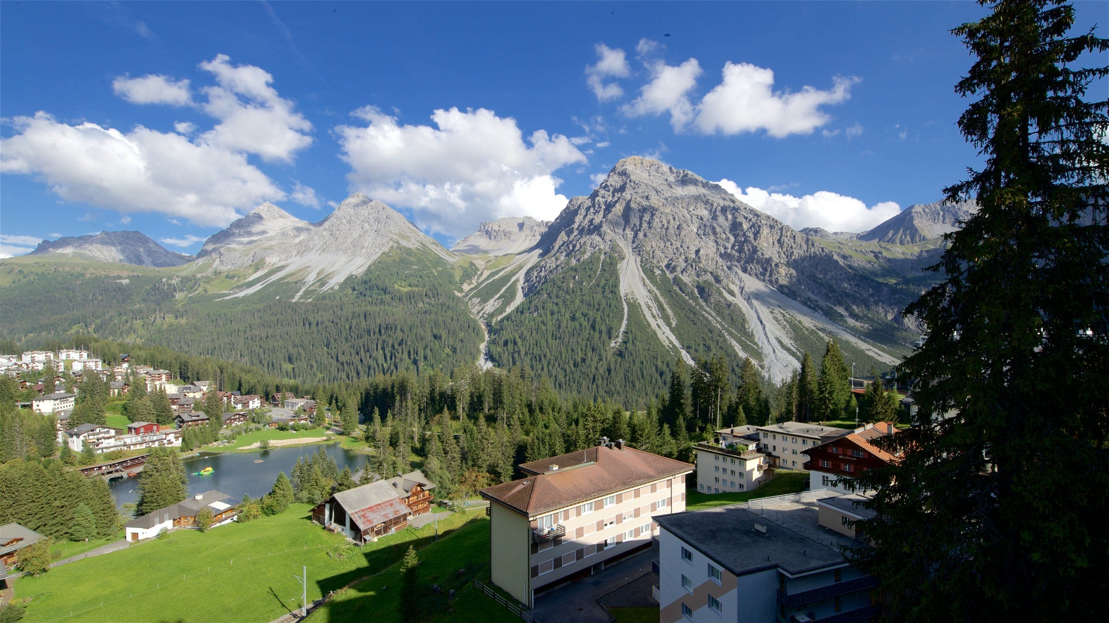 Arosa which includes landscape views, mountains and a small town or village