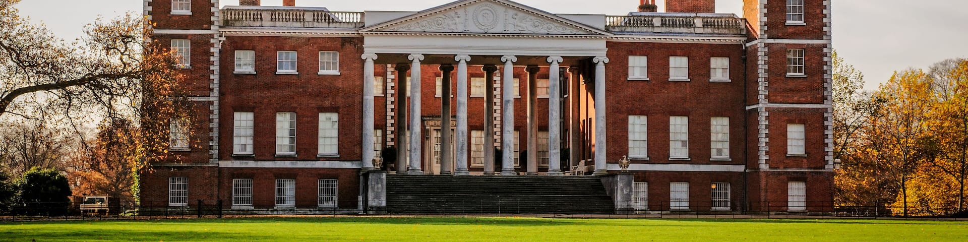 A large brick building with a central portico and two towers.